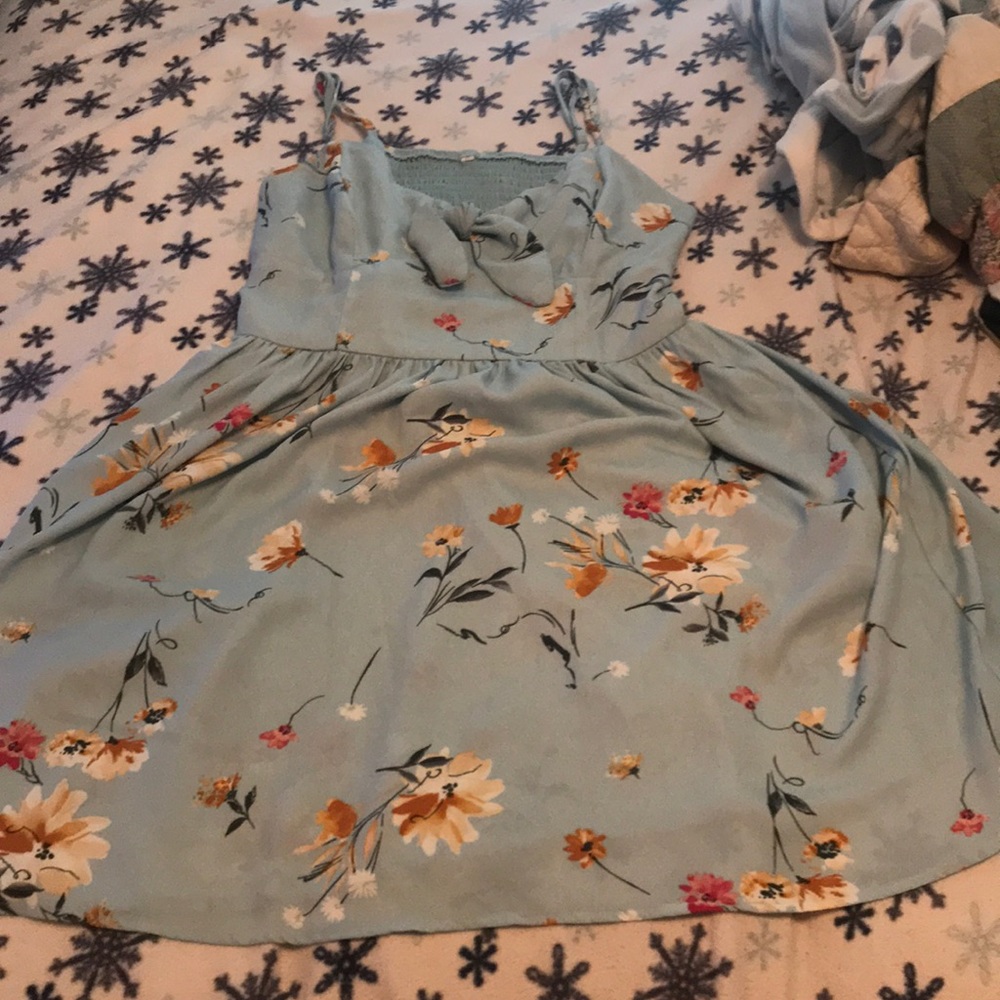 Light blue dress with noodle straps and bow.